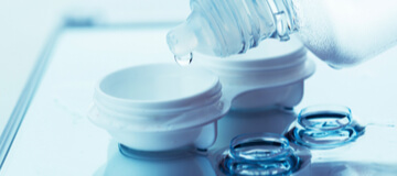 Close-up of contact lens case, contact lenses & solution