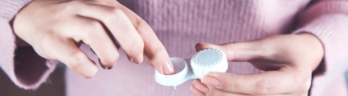 closeup of woman's hands holding a contact lens case, travel concept, travel case for contact lenses