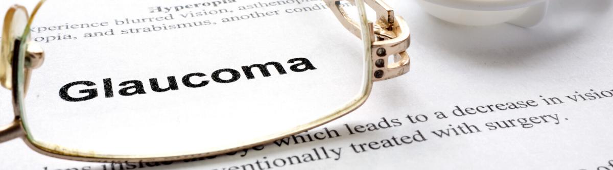 Eye glasses and contact lens case on top of Glaucoma article